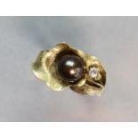 A yellow 14K ring set cultured black pearl & small white stones; size: R; 4.5 gm.