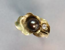 A yellow 14K ring set cultured black pearl & small white stones; size: R; 4.5 gm.