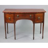 A Georgian mahogany bow-front sideboard fitted three frieze drawers with brass lion-mask & ring