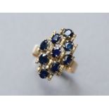 A 14K yellow abstract design ring set nine oval-cut sapphires; size: Q; 4.4 gm.