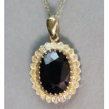 An oval-cut sapphire pendant in 9ct. gold mount, the stone measuring approx. 14 x 9 x 6mm, on a