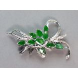 A 14K white leaf-spray brooch set ten green jade leaves; 5.3 cm long. (6.3 gm).