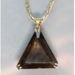 A triangular-cut smokey quartz pendant set in yellow 14K mount with pierced scroll sides, on