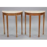 A pair of late 19th/early 20th century continental pine demi-lune console tables with pink & grey