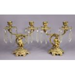 A pair of 19th century ormolu twin-branch candelabra with foliate sconces on figural supports &