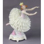 A Sitzendorf porcelain figure of a ballerina on gilt decorated shaped plinth base, 25.5cm high, with