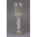 *Amended photos* An 18th century drinking glass with tall crimped bell-shaped bowl on thick knopped