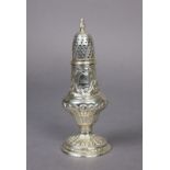 A George III silver sugar castor of inverted pear shape, with all-over repoussé decoration, on