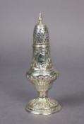 A George III silver sugar castor of inverted pear shape, with all-over repoussé decoration, on