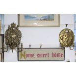 Two ornate brass wall sconces each with an embossed backplate, 16” x 14”, & 11” x 8¾”.