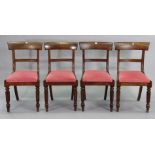 A set of four early 19th century mahogany bow-back dining chairs each with a padded drop-in-