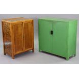 A mid-20th century green painted pine kitchen side cabinet fitted with a centre shelf enclosed by