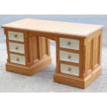 A natural & white painted pine knee-hole desk fitted with an arrangement of six drawers, 53¾” wide x