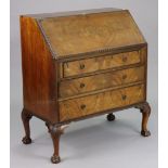 A Georgian-style mahogany bureau having a fitted interior enclosed by a fall-front above three