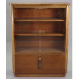 A mid-20th century Abbess teak office side cabinet having two adjustable shelves enclosed by a