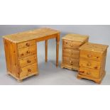 Two pine three-drawer bedside chests, 15½” & 15” wide; & a pine knee-hole desk, 39¾” wide.