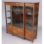 An Edwardian mahogany break-front china display cabinet fitted two shelves enclosed by a glazed