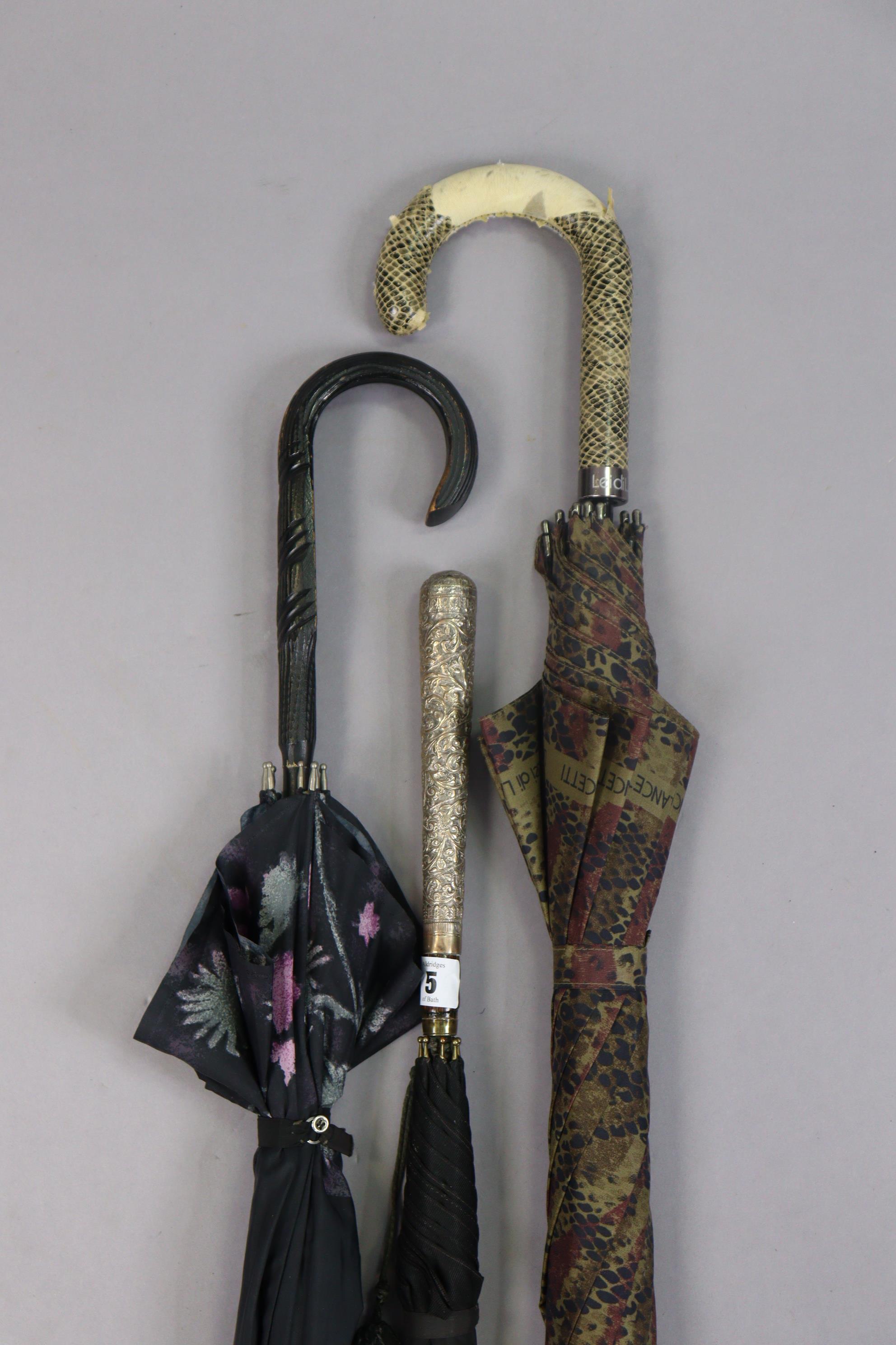 An early/mid-20th century eastern ladies’ umbrella with an embossed white-metal handle; together - Image 2 of 2