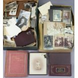 A collection of vintage family photographs & postcards, in albums & loose.