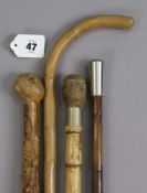 Four various vintage walking canes.