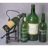 An early 20th century Louis Jadot wrought iron wine bottle holder/pourer with winding mechanism,