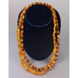 Two amber chip necklaces, each 34cm long.