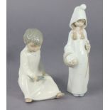 A Lladro Daisa standing girl figure 22cm tall; & a Lladro-type boy figure 15.5cm tall.