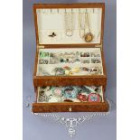 Various items of costume jewellery contained in a wooden jewellery box.