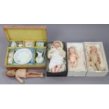 Three Armand Marjeille bisque-head baby dolls; a fabric doll; & a doll’s tea set, boxed.