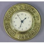 A small Quartz battery-operated wall clock in a brass frame inscribed “EDWIN FODEN & SONS LTD.
