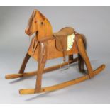 A pine child’s small rocking horse; 38½” wide x 30” high.