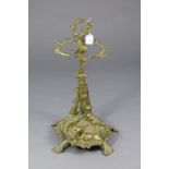 A Victorian-style cast brass stick stand with hunting-theme design, 22” high.