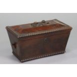 A Victorian mahogany work box of sarcophagus form, with carved rosebud handle to the hinged lid,