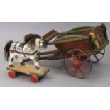 A painted wooden pull-along dapple-grey horse, 35cm wide x 41cm high; & a painted wooden pull-