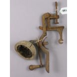 A Victorian wooden cricket ball cleaner/polisher with a cast-iron bracket, 30cm wide.