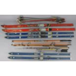 Four fly-fishing rods; three pairs of vintage skis; & three pairs of ski poles.