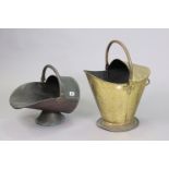 An antique shaped copper helmet-shaped coal scuttle, 26cm high; & a similar brass ditto, 36cm high.