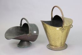 An antique shaped copper helmet-shaped coal scuttle, 26cm high; & a similar brass ditto, 36cm high.