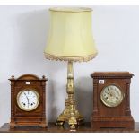 A gilt composition table lamp with shade; & two early 20th century oak cased mantel clocks.
