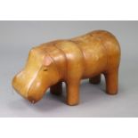 A tan leather novelty Hippo footstool, 76cm long x 38cm high (lacking one ear, over-all wear).