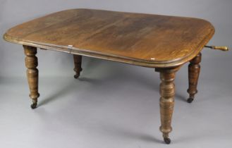 A Victorian oak extending dining table with moulded edge & rounded corners to the rectangular top,