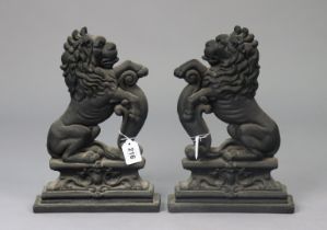 A pair of Victorian-style black painted cast-iron rampant-lion doorstops, 35.5cm high.