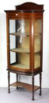 An Edwardian inlaid-mahogany tall bow-front china display cabinet fitted two shelves enclosed by a