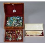 Various items of costume jewellery contained in a leather jewellery box.