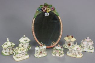 A barbola-type oval dressing table mirror on an easel support, 35.5cm x 25cm; & eight Coalport