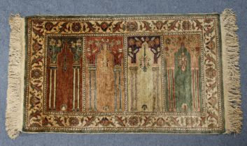 A vintage Turkish Kayseri small rug with central garden design in a floral border, 114cm x 61cm.