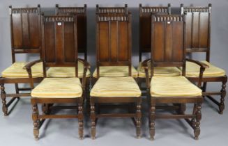 A set of eight Ercol oak dining chairs (including a pair of carvers), each with a panelled back, &