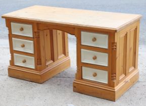 A natural & white painted pine knee-hole desk fitted with an arrangement of six drawers, 53¾” wide x