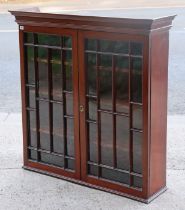 A 19th century mahogany bookcase section having three adjustable shelves enclosed by a pair of