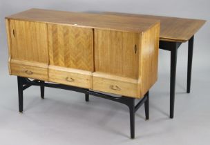A 1960’s teak draw-leaf dining table the black-finish base on four square tapered legs, 29½” x